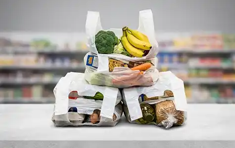 T-Shirt vest shopping bags filled with groceries in supermarket retail application